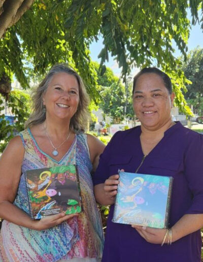 Ho'oikaikab Partnership Kalo boy book Lei & Deb holding book smiling
